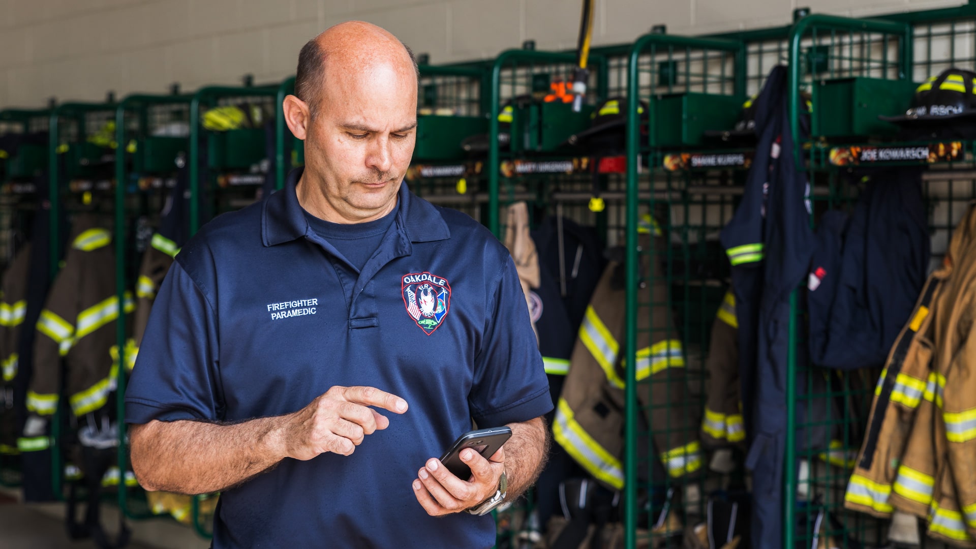 Firefighter filling out a digital form in the Aladtec system