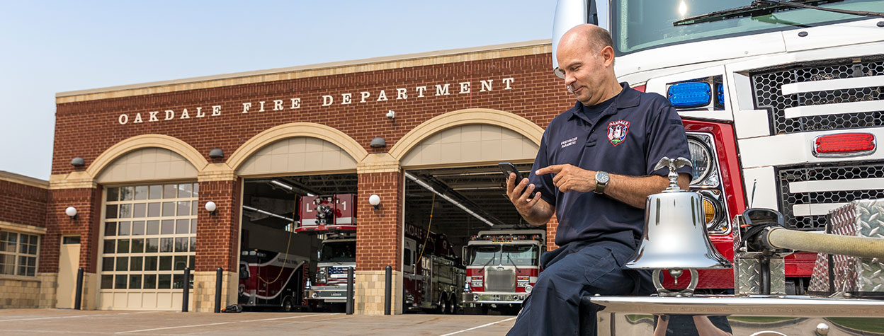 Firefighter contacting Aladtec on a mobile device